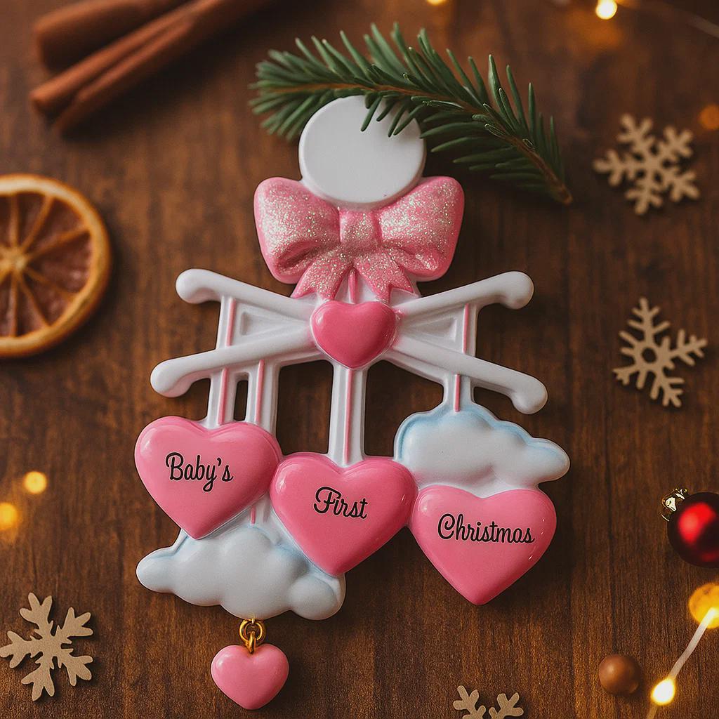 Personalized Baby Girl First Christmas Ornament featuring a dimensional 3D front design with pink glitter bow, heart charms, and hanging cloud detail. The baby’s name is added on the top circle and the year on the cloud, creating a meaningful keepsake. Soft pink tones, layered hearts reading Baby’s First Christmas, and festive holiday accents make it perfect for newborn girl gifts, baby shower presents, and treasured Christmas tree memories.