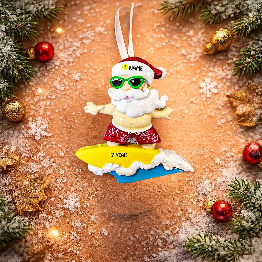 Personalized surfing Santa Christmas ornament featuring a fun beach themed Santa riding a wave on a surfboard. Raised 3D front details add depth while the back remains flat for easy hanging. Custom name and year placement make this ornament a playful and unique holiday keepsake for Christmas tree decor.