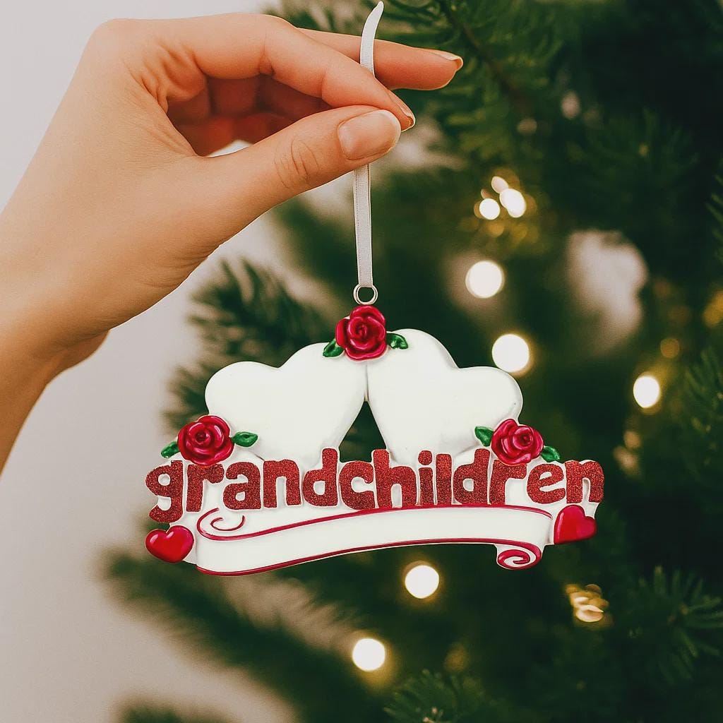 Personalized grandparents Christmas ornament featuring two white heart shapes with custom names, red rose details, glitter red grandchildren lettering and a heartfelt we love you message, designed as a sentimental holiday keepsake for grandparents, displayed on a warm rustic wooden background with cozy Christmas lights, ornaments and festive decor, perfect for celebrating family love and cherished memories during the holiday season