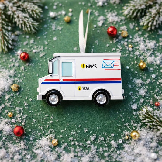 White toy mail truck ornament on a green surface with decorative elements