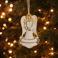 Load image into Gallery viewer, Angel ornament hanging on a Christmas tree with blurred lights in the background
