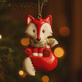Load image into Gallery viewer, Decorative fox ornament with a red scarf hanging on a Christmas tree.
