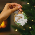 Load image into Gallery viewer, Elegant engagement Christmas ornament featuring gold accents white florals and the phrase she said yes. Personalized with a custom date to commemorate a proposal or engagement moment. A romantic keepsake perfect for celebrating newly engaged couples weddings and meaningful holiday memories.
