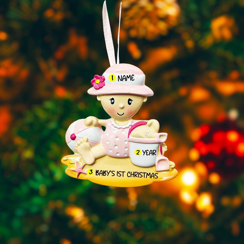 Personalized baby first Christmas ornament for baby girl featuring a beach and summer inspired design. This adorable keepsake includes handwritten name and year personalization, a soft pink baby figure, sand details and playful seaside elements. The ornament has a lightweight 2D base with raised 3D detailing on the front only. Perfect for baby’s first Christmas, nursery decor, coastal holiday themes and meaningful family gifts.