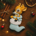 Load image into Gallery viewer, A glossy resin baby deer ornament features a cute fawn character sitting inside a soft pastel blue winter boot, holding a striped candy cane, with gentle antler details, smooth painted cartoon style finish, soft holiday lighting and blurred festive background, handwritten personalization showing the baby name on the boot and the year or Baby’s First Christmas text below, designed as a mostly 2D ornament with raised 3D details on the front only.
