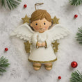 Load image into Gallery viewer, Decorative angel ornament with wings and halo on a snowy background with Christmas decorations.
