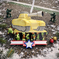 Load image into Gallery viewer, A resin Army tank ornament in bold yellow features a cartoon style military tank with detailed black tracks and raised cannon, camouflage green ARMY lettering across the front, a star accent and American flag inspired base, surrounded by snow texture and festive holiday elements, with handwritten personalization showing one name on the left banner and the year on the right banner, designed as a mostly 2D ornament with raised 3D details on the front only for lightweight Christmas tree decor.
