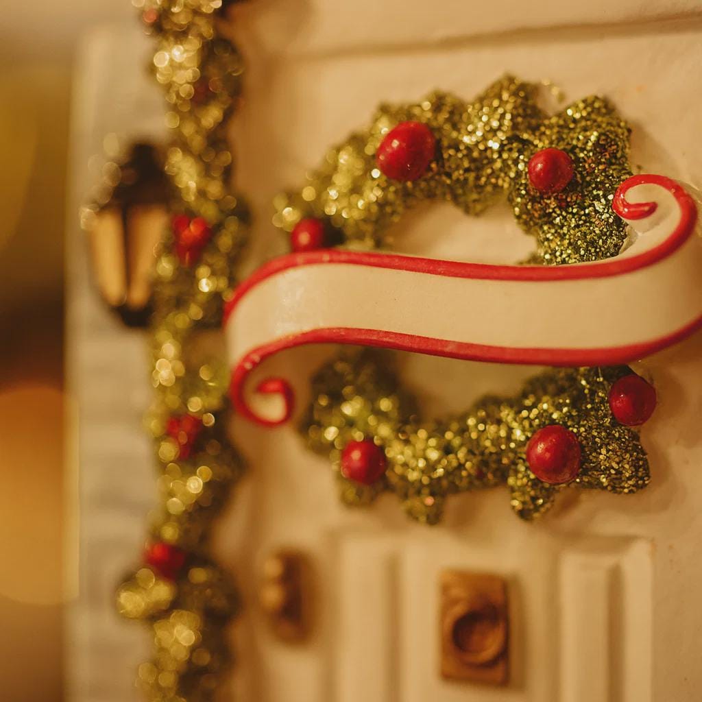Decorative gingerbread house with a wreath design on a blurred background