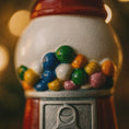 Load image into Gallery viewer, Close-up of a gumball machine with colorful gumballs against a blurred background
