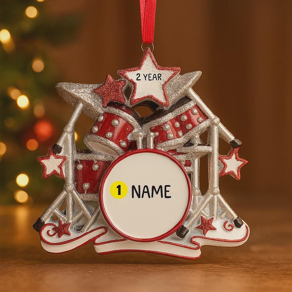Personalized drum set ornament featuring a detailed red and silver drum kit with cymbals and star accents. Customizable with one name and a year. Crafted from resin with a glossy finish, featuring 3D raised front drum elements and a flat 2D back for balanced hanging. Finished with a satin ribbon. Designed for drummers musicians band members and music themed Christmas tree decor.
