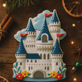 Load image into Gallery viewer, Personalized Princess Castle Christmas Ornament featuring a charming white fairytale castle with blue rooftops and red flags, surrounded by colorful floral details. Customizable with name at the base and year on the castle front, this magical princess castle ornament is perfect for celebrating a special little girl. 
