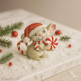 Load image into Gallery viewer, Decorative figurine of a mouse in a Santa hat with candy canes on a snowy surface with Christmas decorations.

