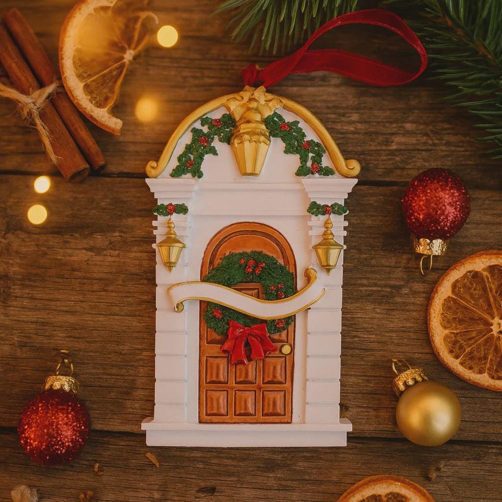 Decorative Christmas door ornament with wreath and bow on a wooden surface with festive decorations.