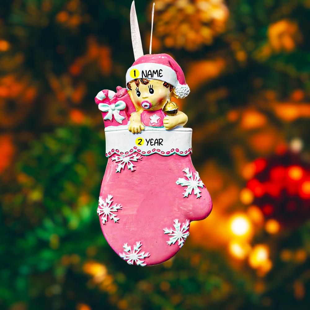 Personalized Baby Girl Christmas Ornament featuring a sweet baby in a pink stocking with raised 3D front details and textured snowflake accents. The name is added on the hat and the year on the stocking, creating a meaningful newborn keepsake. Soft pink tones, holiday elements, and dimensional design make it perfect for baby’s first Christmas, baby girl gift, and special family memory ornament for the tree.