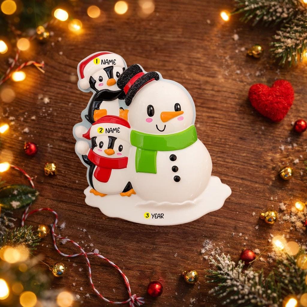 Decorative snowman with penguins on a wooden surface with festive decorations.