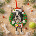 Load image into Gallery viewer, Dog ornament with customizable name and year, surrounded by Christmas decorations on a sandy background.
