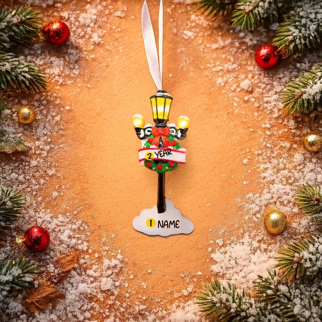 Decorative Christmas ornament with a streetlight design on a snowy background.