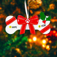 Load image into Gallery viewer, Festive pet themed Christmas ornament designed in a bone shape with a red holiday bow and paw detail. Featuring classic Christmas colors and a warm seasonal background, this ornament adds a joyful and loving touch to pet themed Christmas tree decor. Designed to be personalized with a name and year, making it a meaningful keepsake for pet owners and animal lovers.

