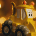 Load image into Gallery viewer, Close-up of a yellow ornament bulldozer with a smiling face on a blurred background
