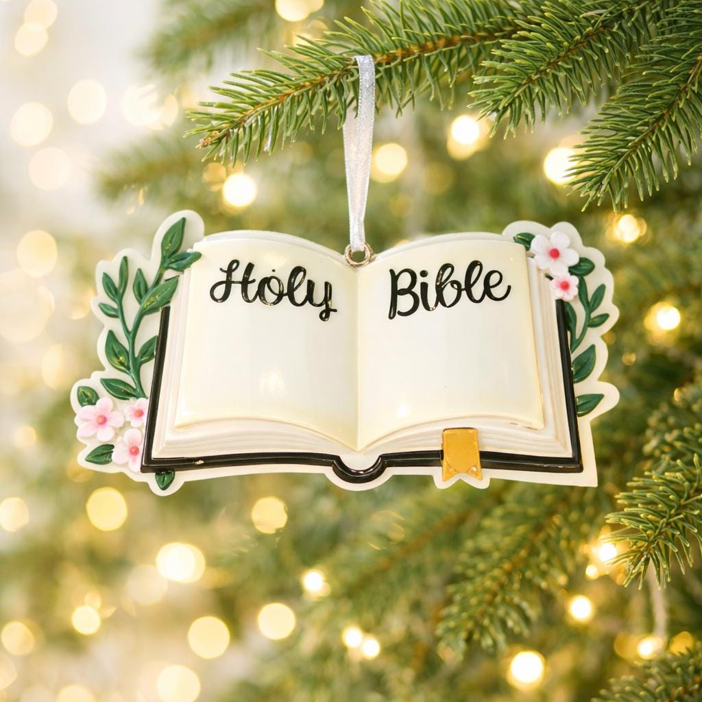 Personalized Holy Bible Christmas Ornament featuring an open scripture design with elegant “Holy Bible” lettering across the pages. The left page is customized with a name and the right page displays the year, creating a meaningful faith based keepsake. Surrounded by soft greenery and delicate flowers, this religious ornament is perfect for baptisms, baby dedications, first communions, or celebrating a Christ centered Christmas. A thoughtful spiritual gift for families who cherish their faith.