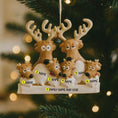 Load image into Gallery viewer, Decorative reindeer family ornament on a Christmas tree with blurred lights in the background.

