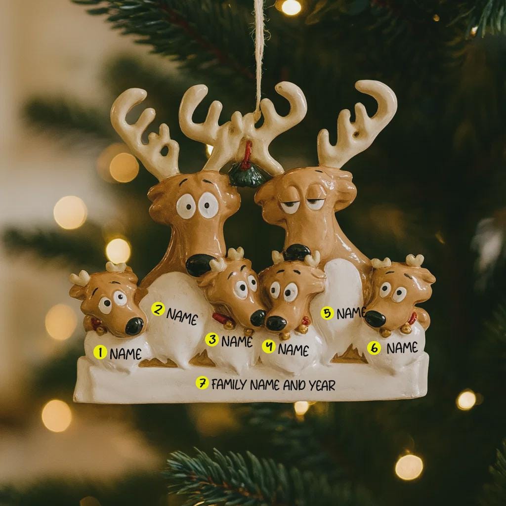Decorative reindeer family ornament on a Christmas tree with blurred lights in the background.