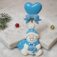 Load image into Gallery viewer, Decorative snowman ornament with blue heart and bow on a light background
