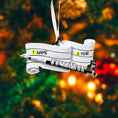 Load image into Gallery viewer, Decorative ornament shaped like a book with customizable text on a blurred Christmas tree background.
