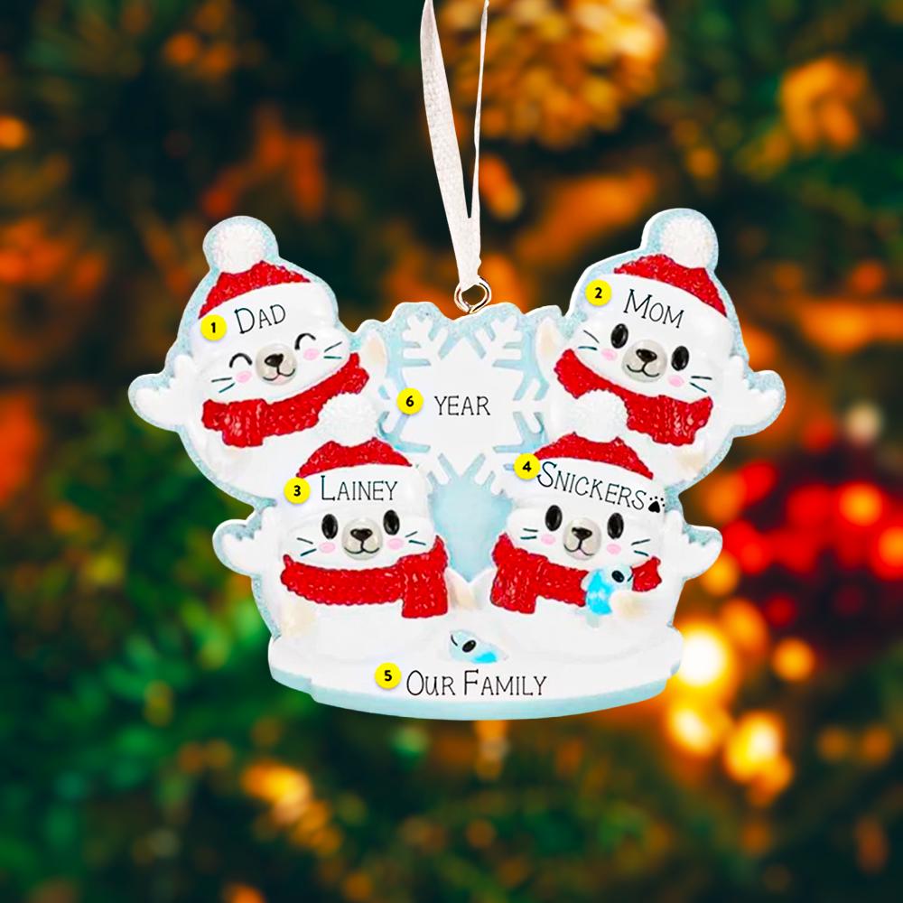 Personalized Christmas ornament with cartoon family of four wearing winter hats and scarves against a blurred festive background.