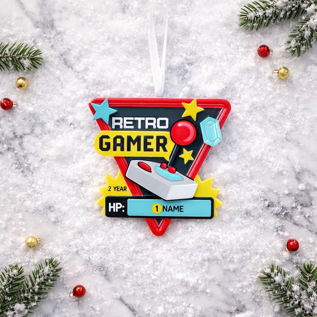 Personalized retro gamer Christmas ornament featuring a classic arcade style joystick and bold gaming icons. Raised 3D front details create depth while the back remains flat for easy hanging. Custom name and year placement make this ornament a fun and nostalgic keepsake for gamers and holiday tree decor.