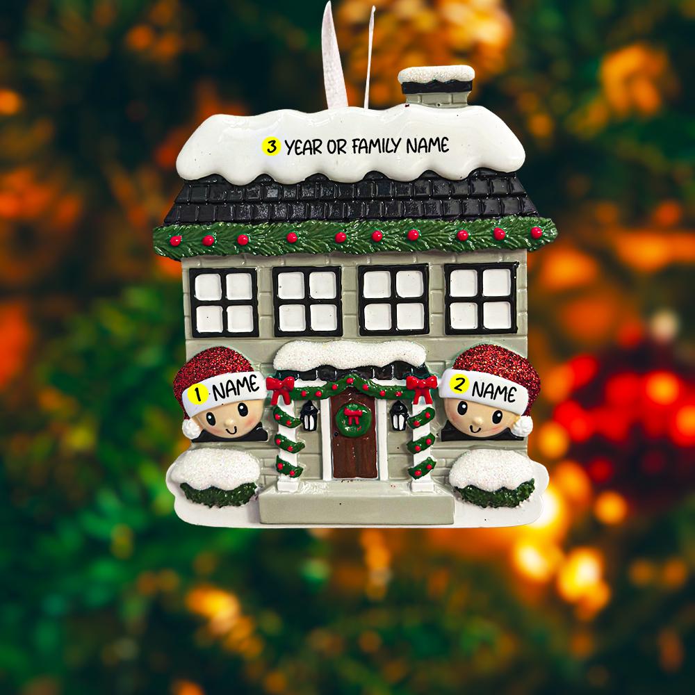 Personalized Christmas house ornament featuring a cozy winter home decorated with snow, wreaths, garlands, and festive details. Two smiling characters wearing Santa hats peek from the front, each customizable with a name, while the roof displays a year or family name. Designed with a detailed 3D raised front and smooth finish, this ornament is perfect for Christmas tree decor, family keepsakes, new home celebrations, and holiday gifting.
