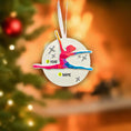 Load image into Gallery viewer, Decorative ornament with a dancer silhouette and customizable text, against a blurred Christmas tree background.
