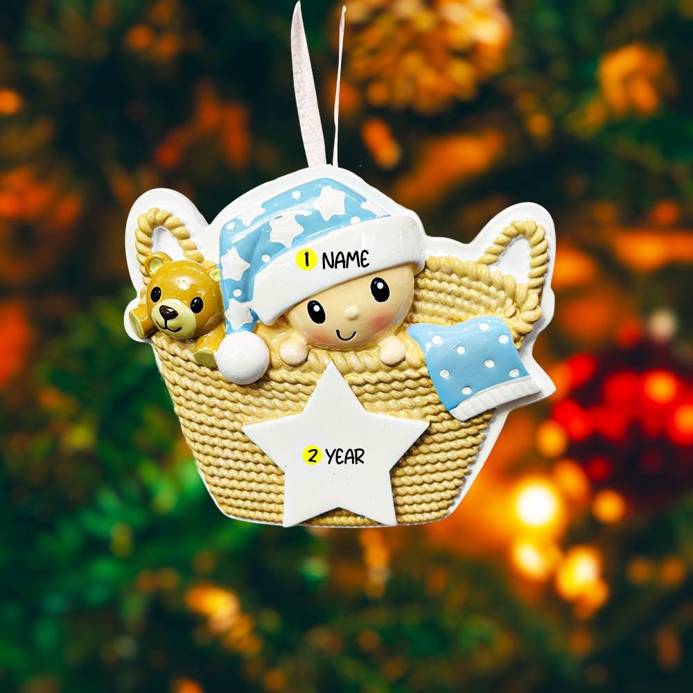 Personalized Baby First Christmas Ornament featuring a sweet newborn tucked inside a cozy woven basket with a soft blue star hat and matching blanket. This 3D front design includes raised details, textured knit pattern, and adorable teddy bear accent, creating depth and charm. Name is displayed on the hat and year on the star. A heartfelt keepsake for baby’s first holiday, nursery decor, or newborn gift. Perfect Christmas tree ornament for new parents.