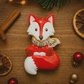 Load image into Gallery viewer, Fox-shaped candle with a checkered scarf on a wooden surface with cinnamon sticks and oranges.
