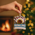 Load image into Gallery viewer, Bowling themed Christmas ornament featuring a raised 3D bowling ball striking detailed bowling pins on a shield style base. Personalized name and year placement is clearly visible on the front. Festive holiday styling with sports inspired details makes this ornament a perfect keepsake for bowling fans league players and Christmas tree decor.
