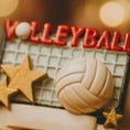 Load image into Gallery viewer, Decorative volleyball with 'Volleyball' text and stars on a blurred background
