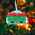 Load image into Gallery viewer, Christmas ornament resembling a train car with red ornaments and name tags against a blurred Christmas tree background.
