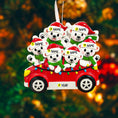 Load image into Gallery viewer, Decorative ornament with polar bears in a red car against a blurred Christmas tree background
