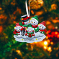 Load image into Gallery viewer, Personalized snowman family ornament with names against a blurred Christmas tree background
