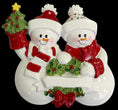 Load image into Gallery viewer, Decorative snowman couple ornament with a black background
