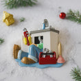Load image into Gallery viewer, Decorative ornament of a plumber working on a sink with tools, surrounded by Christmas decorations.
