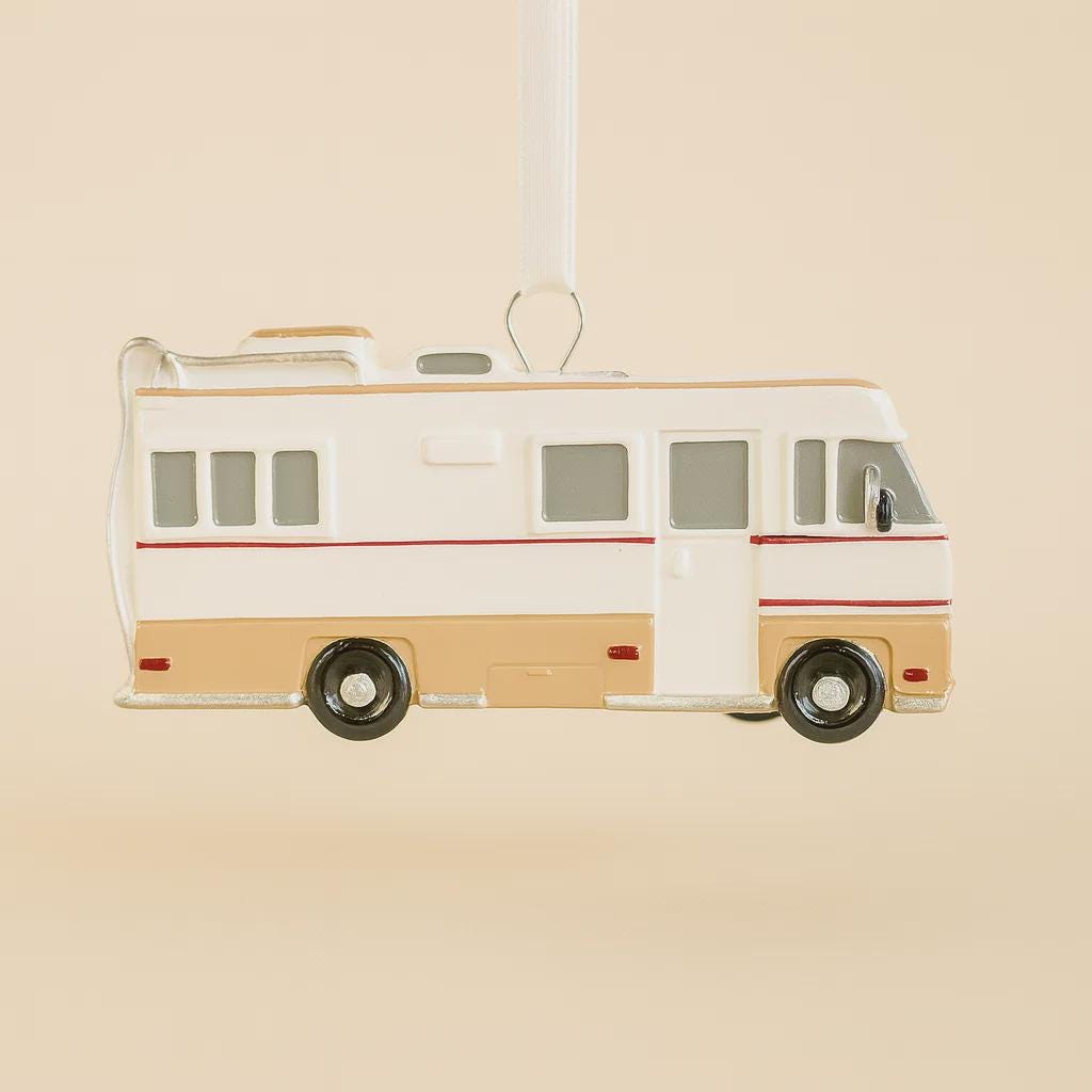Model of a retro-style RV on a beige background