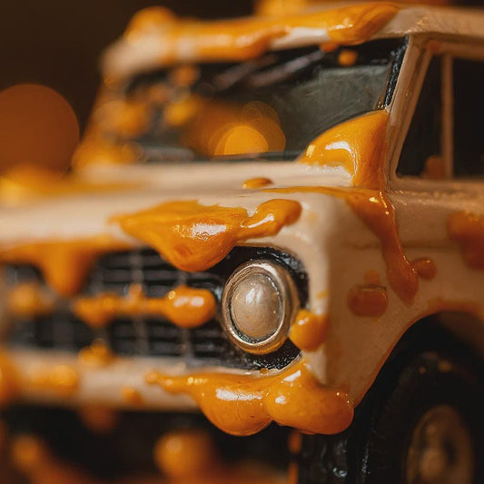 Close-up of a toy car with orange substance on it