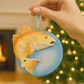 Load image into Gallery viewer, Decorative fish ornament held by a hand with a blurred festive background
