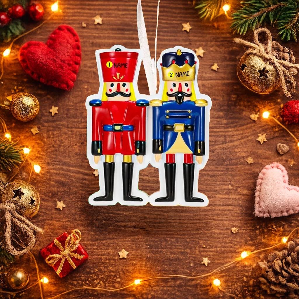 Festive close up of a personalized nutcracker couple ornament featuring two classic nutcracker figures in red and blue uniforms with custom name details. Designed for couples, partners, siblings, or loved ones, this ornament symbolizes balance, tradition, and togetherness. A timeless Christmas keepsake ideal for tree decor, holiday gifting, and celebrating meaningful bonds.

