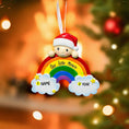 Load image into Gallery viewer, Decorative ornament with a baby figure and rainbow, placed on a Christmas tree.
