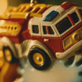 Load image into Gallery viewer, Close-up of a colorful toy fire truck with a blurred background
