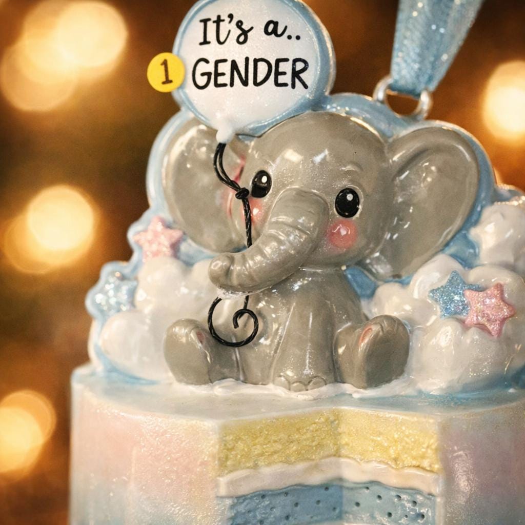 Decorative elephant ornament with 'It's a 1 GENDER' text on a blurred background