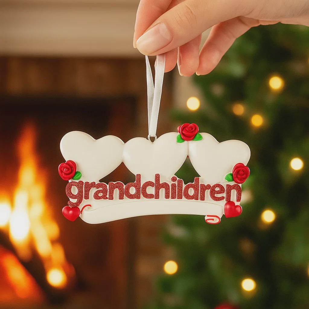 Decorative ornament with 'grandchildren' text held by a hand against a festive background.