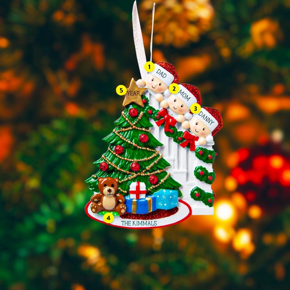 Personalized Christmas ornament with family of four and a tree, against a blurred festive background.